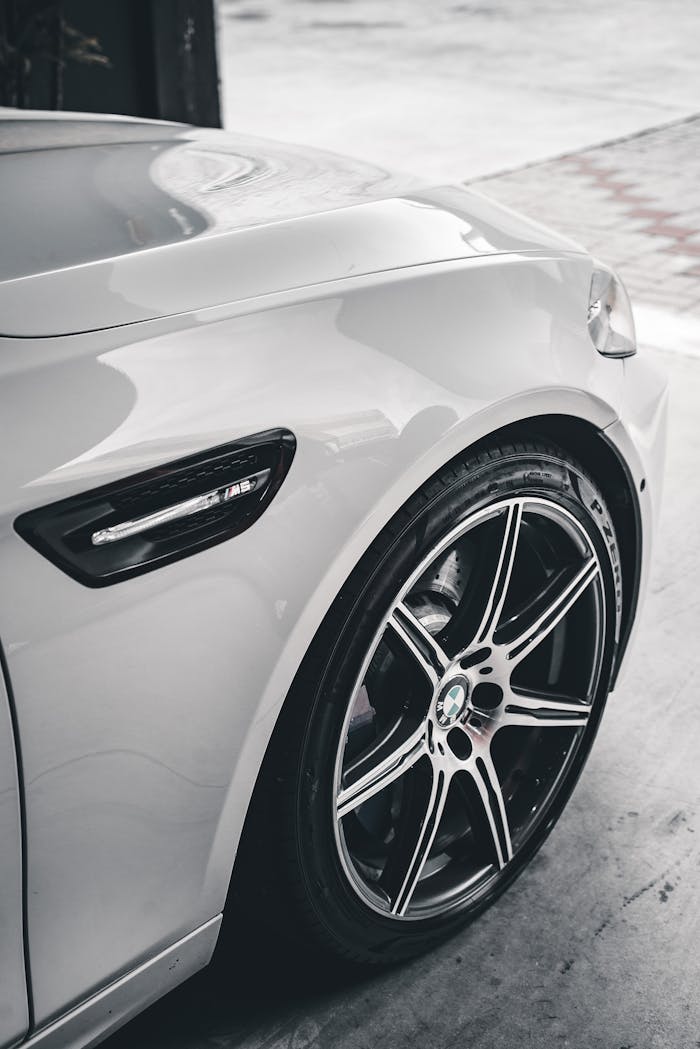 services-img Elegant close-up shot of a modern car wheel showcasing design and detail.